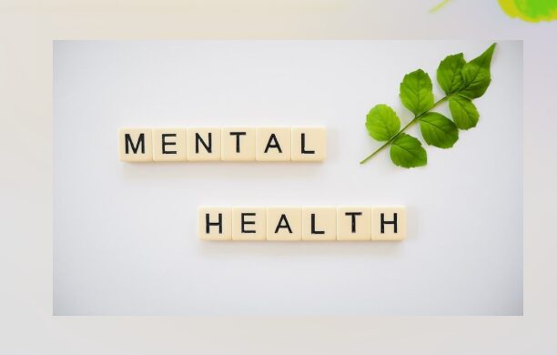 A white table with scrabble tiles that spell out mental health.